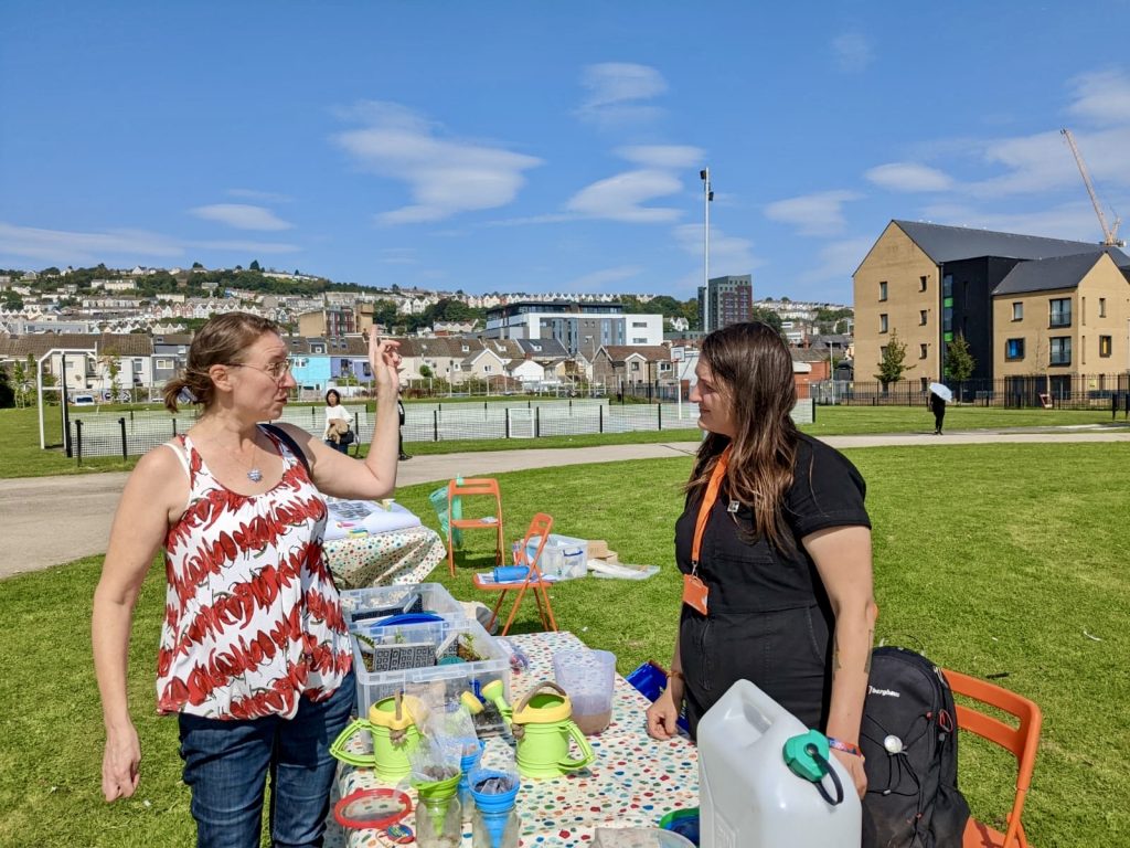 Tatiana speaking to a member of the community about the green space project